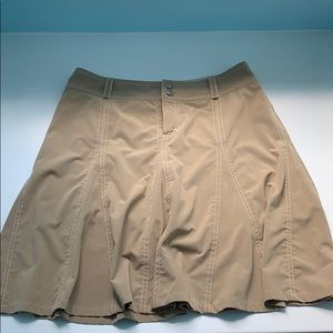 Tan Athleta skort with white stitching